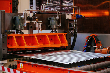 Modern roll forming machine in metal profiling workshop