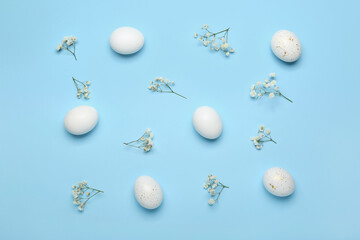 Composition with beautiful Easter eggs and gypsophila flowers on color background