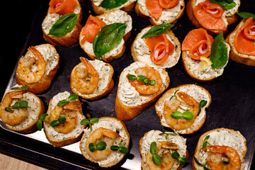 Top view of various Bruschettas with salmon and shrimps. Seafood sandwiches.