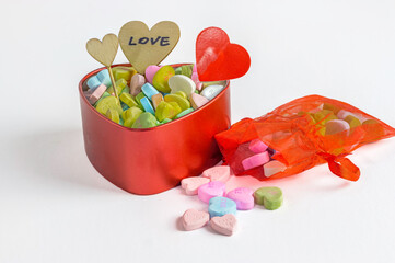 heart shaped box filled with Valentine's Day Candies, love sign, white background