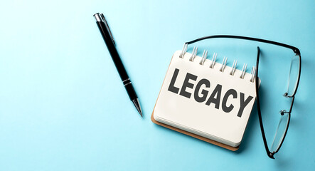 LEGACY text written on a notepad on the blue background