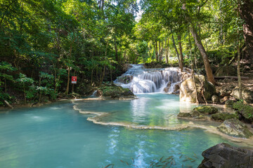 Erawan National Park in Thailand. Erawan Waterfall is a popular tourist destination and famous for its emerald blue water. Deep forest in tropical climate with fantasy atmosphere.	
