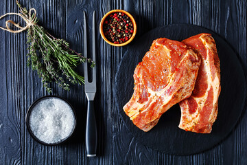 raw marinated pork chops on a plate