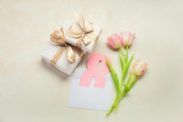 Composition with tulip flowers, gift boxes and paper figure 8 on light background. International Women's Day celebration