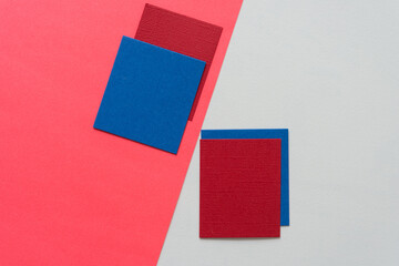 blue and red paper squares arranged on a light background