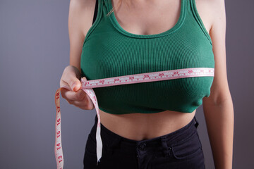 young girl measures her breasts
