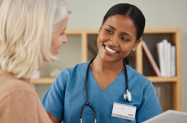 Dont leave home, Ill come to you. Shot of a doctor using a digital tablet during a consultation...