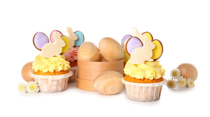 Yummy Easter cupcakes with wooden eggs and flowers on white background