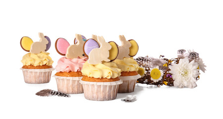 Tasty Easter cupcakes and flowers on white background