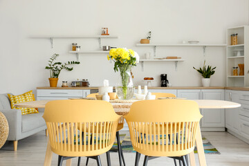 Dining table with setting served for International Women's Day celebration in modern kitchen