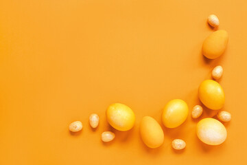 Composition with Easter eggs on orange background