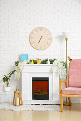 Interior of light living room with fireplace, armchair and Easter eggs