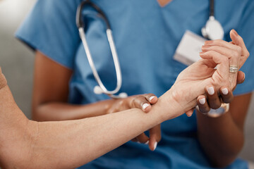 Fototapeta premium Keep your finger on the pulse of your health. Shot of a doctor examining a senior womans pulse during a consultation at home.