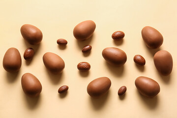 Different chocolate Easter eggs on beige background