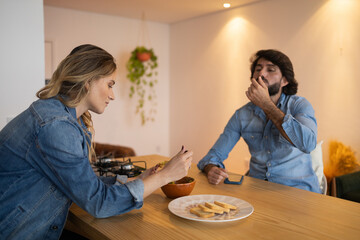 Young couple in love eating a super healthy guacamole salad with whole toast in the kitchen. High quality photo