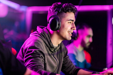 A smiling gamer winning tournament in video game at gaming room.