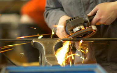 Cutting metal with many sharp sparks as background