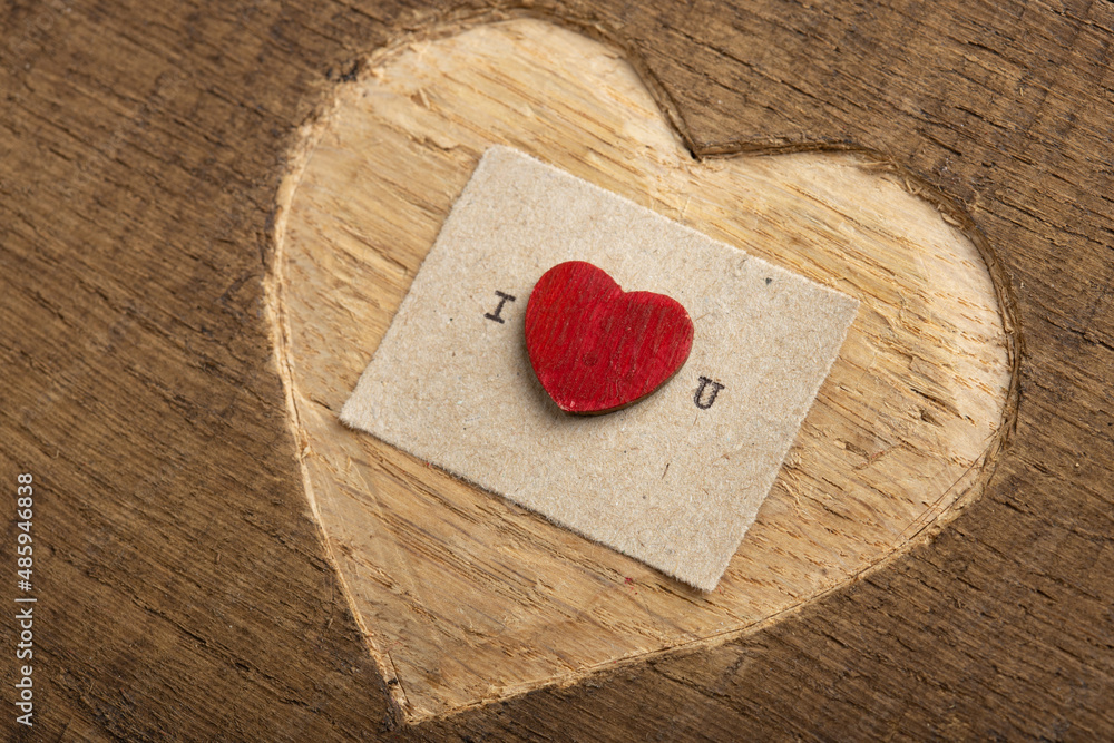 Fototapete i love you - tiny typed text note close up. valentines day greetings concept. carved heart shape on 