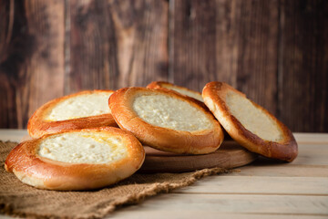 Homemade buns with cottage cheese on wooden background. Gluten free pastries.