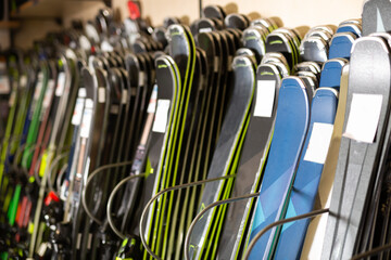 Ski shop sale. Rows of colourful alpine skis in modern sport equipment store