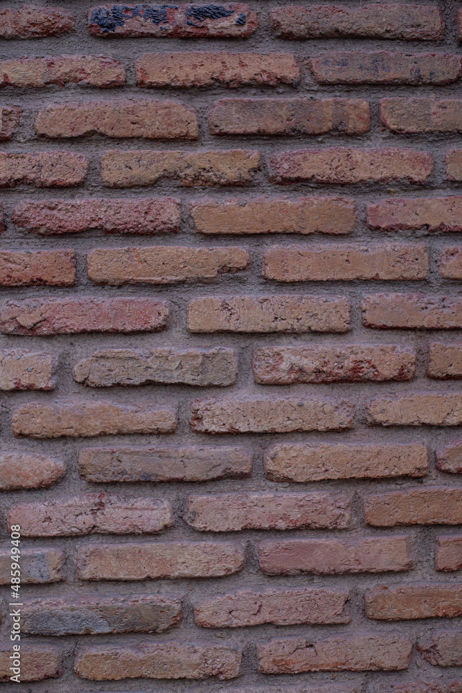 Wall mural a closeup shot of a brown old brick wall