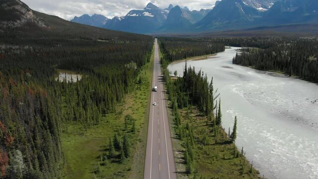 Aerial view of vehicles driving down the iconic Icefields Parkway route between Banff and Jasper National Parks in Alberta, Canada.