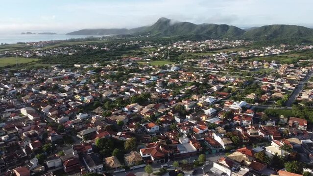 Beautiful seaside town with the sun rising - drone view - panorama - tropical beach - Arma&ccedil;&atilde;o de B&uacute;zios, Rio de Janeiro, Brazil