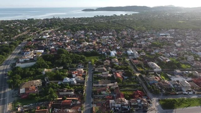 Beautiful seaside town with the sun rising - drone view - panorama - tropical beach - Arma&ccedil;&atilde;o de B&uacute;zios, Rio de Janeiro, Brazil