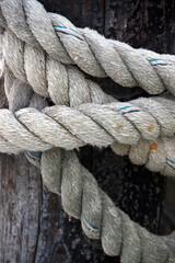 Fototapeta na wymiar Close-up view of a heavy and strong rope tied around a wooden post
