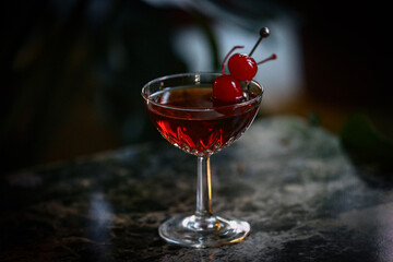 Manhattan cocktail in glass with cherry garnish 