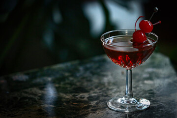 Manhattan cocktail in glass with cherry garnish 