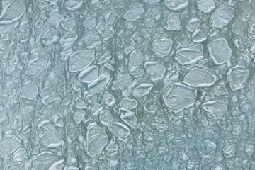 In winter, the sea froze, turning into an ice field of frozen ice floes. Background of frozen ice cubes. Winter day frozen sea view from above on sea water ice texture.