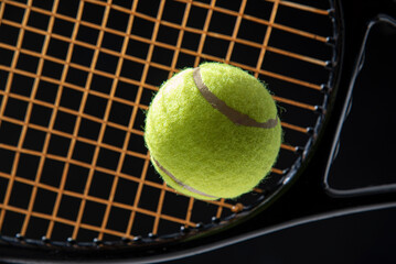 tennis ball with racket isolated black background