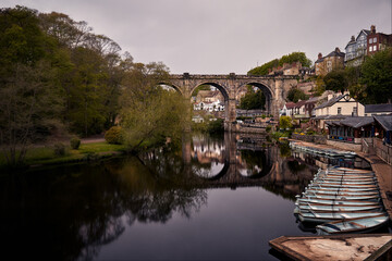 A beautiful view of the Nidd river, the old bridge, and rowing boats from the ruins of...