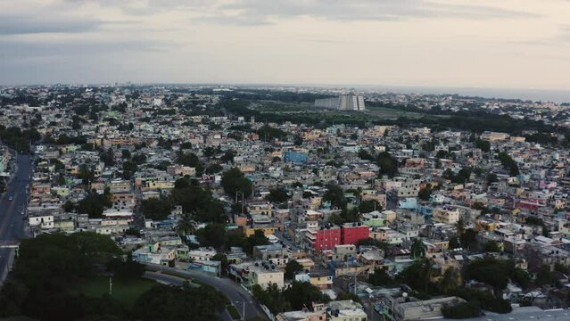 AERIAL - Dusk over the urban sprawl of Santo Domingo, Dominican Republic, forward