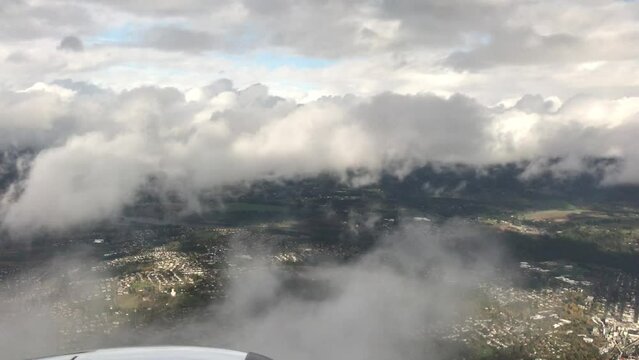 plane flying above large clouds 