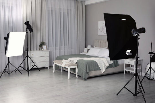 Professional photo studio equipment prepared for shooting bedroom interior