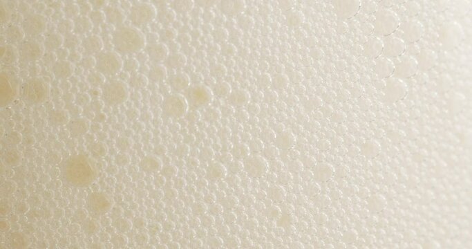 Many beer foam on the surface of the drink. Soft white foam on the surface of the drink. Food concept.