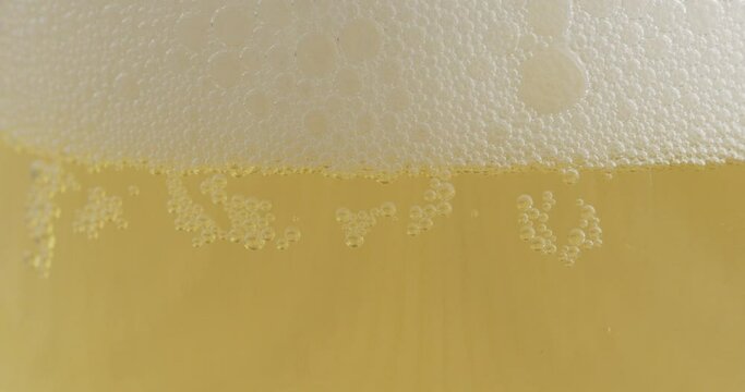 Foam of the drink on the water surface after pouring. After pouring Alcohol creates foam. Food concept.