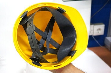 Photo of a yellow safety helmet, this helmet is usually used by construction workers to protect the...