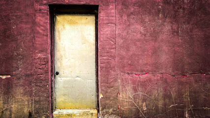 yellow faded door red stucco wall alley entrance grunge old deserted empty copy space architectural backdrop
