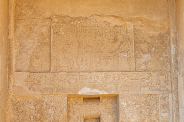 hieroglyph on the wall of the temple near Giza pyramids in Giza,