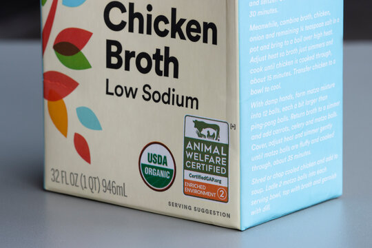 Portland, OR, USA - Feb 8, 2022: Closeup of Global Animal Partnership's Animal Welfare Certified and USDA Organic labels on a carton box of organic chicken broth distributed by Whole Foods Market.