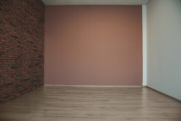 Empty room with different walls, white door and wooden floor