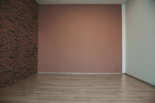 Empty room with different walls, white door and wooden floor © New Africa