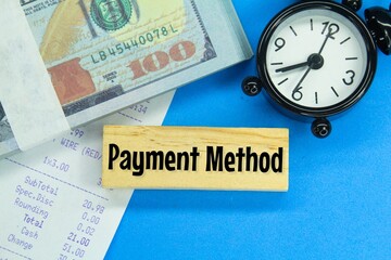 banknotes, alarm clocks, receipts and wooden boards with the words payment methods