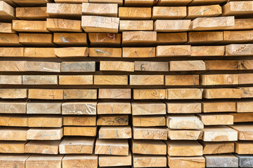 Wooden stack made of wooden blanks. Filling background made of lumber. Text for advertising on a background of boards.