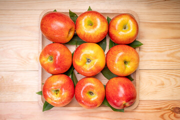 Fresh red Envy apple  on wooden background. Envy apple on wooden box packaging ready to sell.