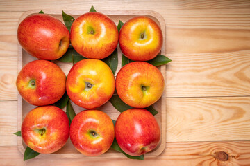 Fresh red Envy apple  on wooden background. Envy apple on wooden box packaging ready to sell.