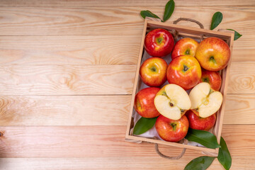 Fresh red Envy apple in wooden basket on wooden background. Envy apple on wooden box packaging ready to sell.